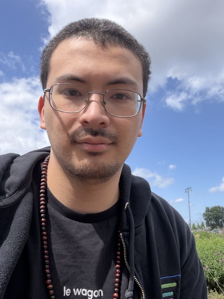 Tyler Chang outdoors beneath a blue sky